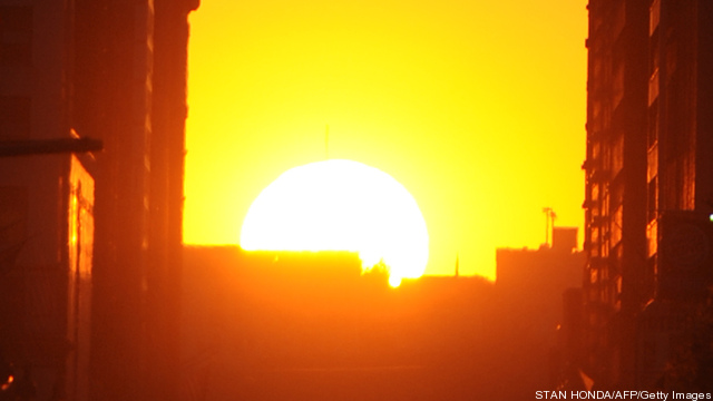 The sun sets along 34th Street, aligning