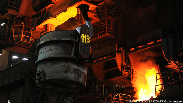 A steel worker drives a crane at the fur