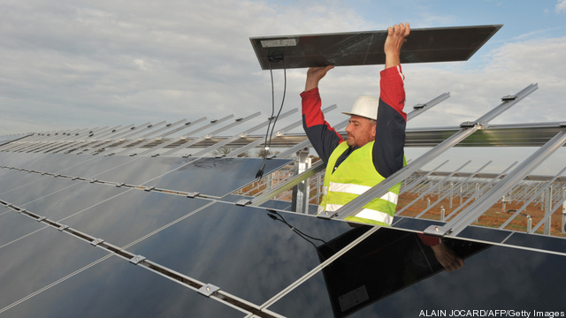 A worker puts on solar panels on Novembe