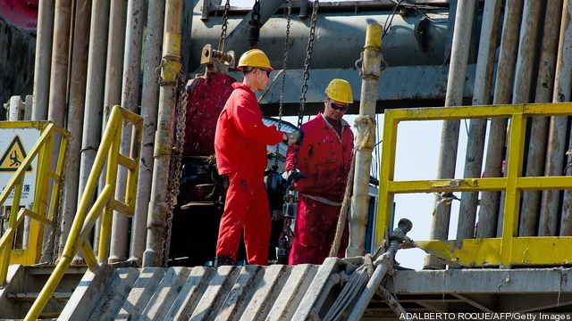 Employees work in an oil rig operated by