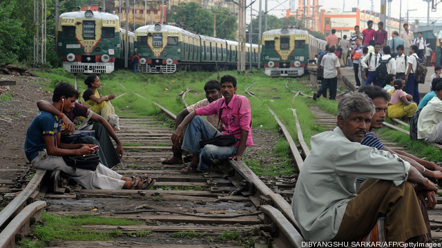 Indian passengers sit on the railway tra