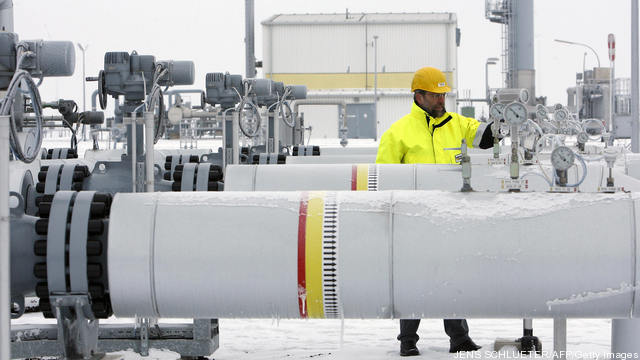 An employee controls the pressure gauge