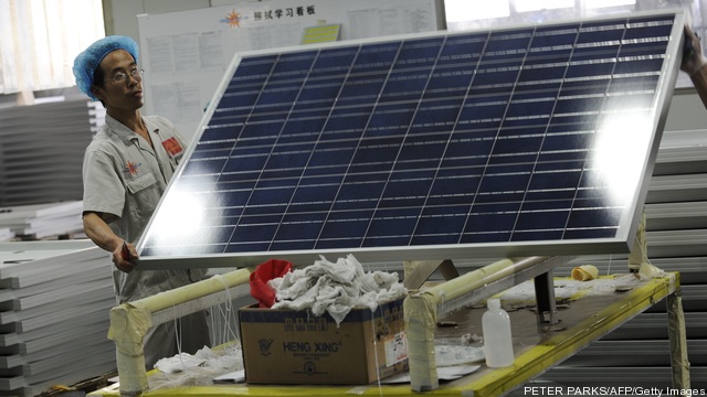 A worker lifts a solar panal in the Ying