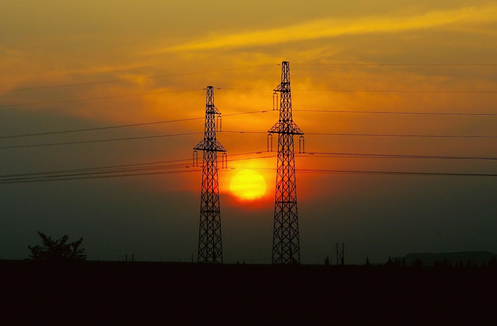 The Sun Sets Down Between Transmit Electricity Towers In Shihezi