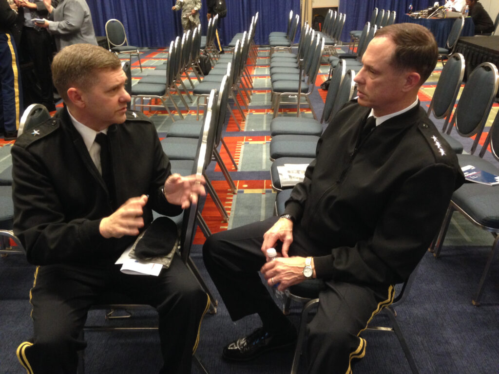 Army Maj. Gen. Hughes (left) and Lt. Gen. Walker (right) discuss the services' network upgrade plans.