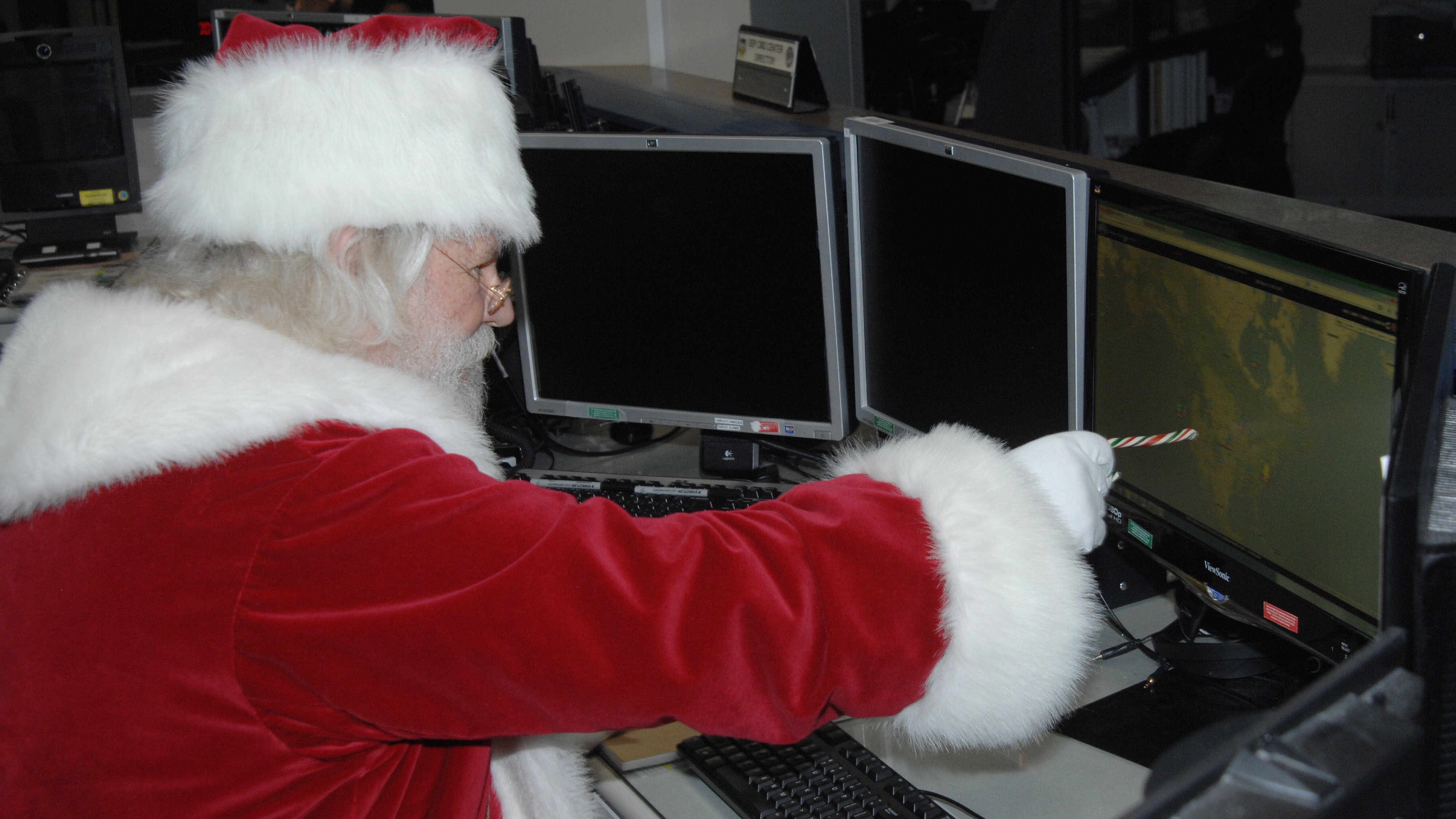 Santa Claus reviews his flight plan for his Dec. 25 trek across the globe in the North American Aerospace Defense Command and U.S. Northern Command Current Operations Center NOTE-- this is from 2013