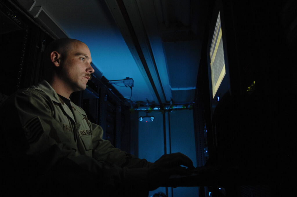 A soldier checks on a server display.