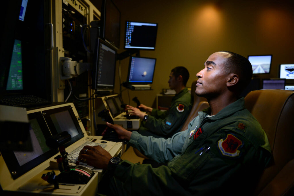 Maj. Bishane, a 432nd Aircraft Maintenance Squadron MQ-9 Reaper pilot, controls an aircraft from Creech Air Force Base, Nev. Remotely piloted aircraft pilots work closely with intelligence officers, sensor operators and maintainers to complete mission objectives. RPA personnel deal with the stressors of deployed service members while maintaining the normalcy of their day-to-day lives through programs designed to enhance communication skills, family and spiritual growth. (U.S. Air Force photo/Staff Sgt. Vernon Young Jr.)
