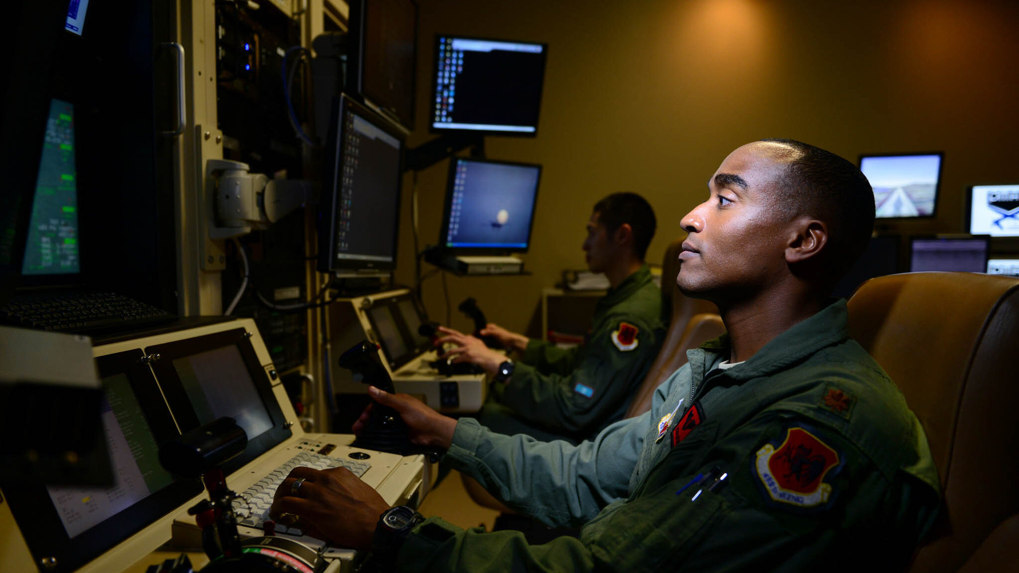 Maj. Bishane, a 432nd Aircraft Maintenance Squadron MQ-9 Reaper pilot, controls an aircraft from Creech Air Force Base, Nev. Remotely piloted aircraft pilots work closely with intelligence officers, sensor operators and maintainers to complete mission objectives. RPA personnel deal with the stressors of deployed service members while maintaining the normalcy of their day-to-day lives through programs designed to enhance communication skills, family and spiritual growth. (U.S. Air Force photo/Staff Sgt. Vernon Young Jr.)