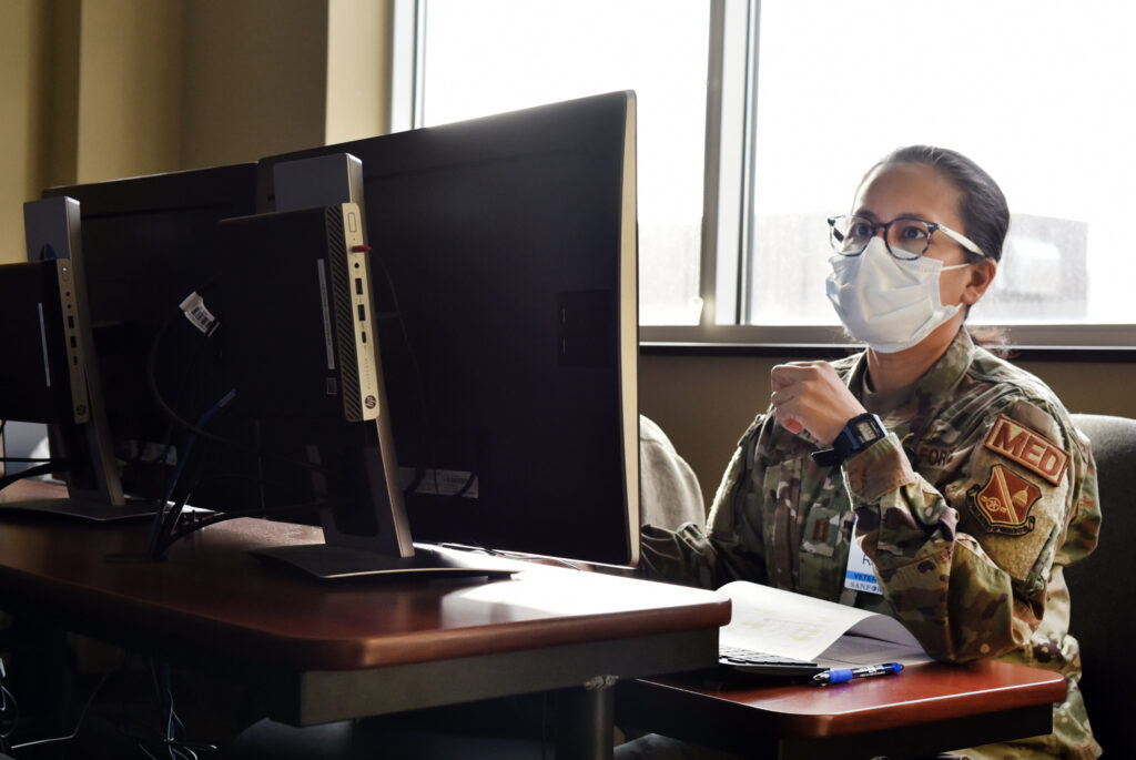 Capt. Eliza Pacis, a U.S. Air Force nurse assigned to the 62nd Medical Brigade, based out of Joint Base Lewis-McCord, Wash., learns the ins and outs of Sanford Health Medical Center's electronic medical records system before integrating into North Dakota’s hospital network to work along their civilian partners to fight COVID-19, Nov. 24, 2020. Before integrating into the hospital the nurses must learn how to use the hospital’s record keeping system to be able to work as if they were part of the hospital’s own staff. U.S. Northern Command, through U.S. Army North, remains committed to providing flexible Department of Defense support to the Federal Emergency Management Agency in support of the whole-of-America COVID-19 response. (U.S. Army Photo by Master Sgt. Helen Miller)