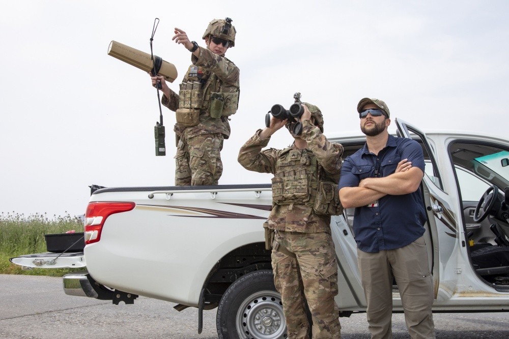 U.S. Army Sgt. Gage Stancell, right, looks through binoculars as Sgt. Gentry Squier describes where he saw a drone during an unmanned aerial system training exercise at Erbil Air Base in the Kurdistan Region of Iraq, April 24, 2020. (Spc. Angel Ruszkiewicz)