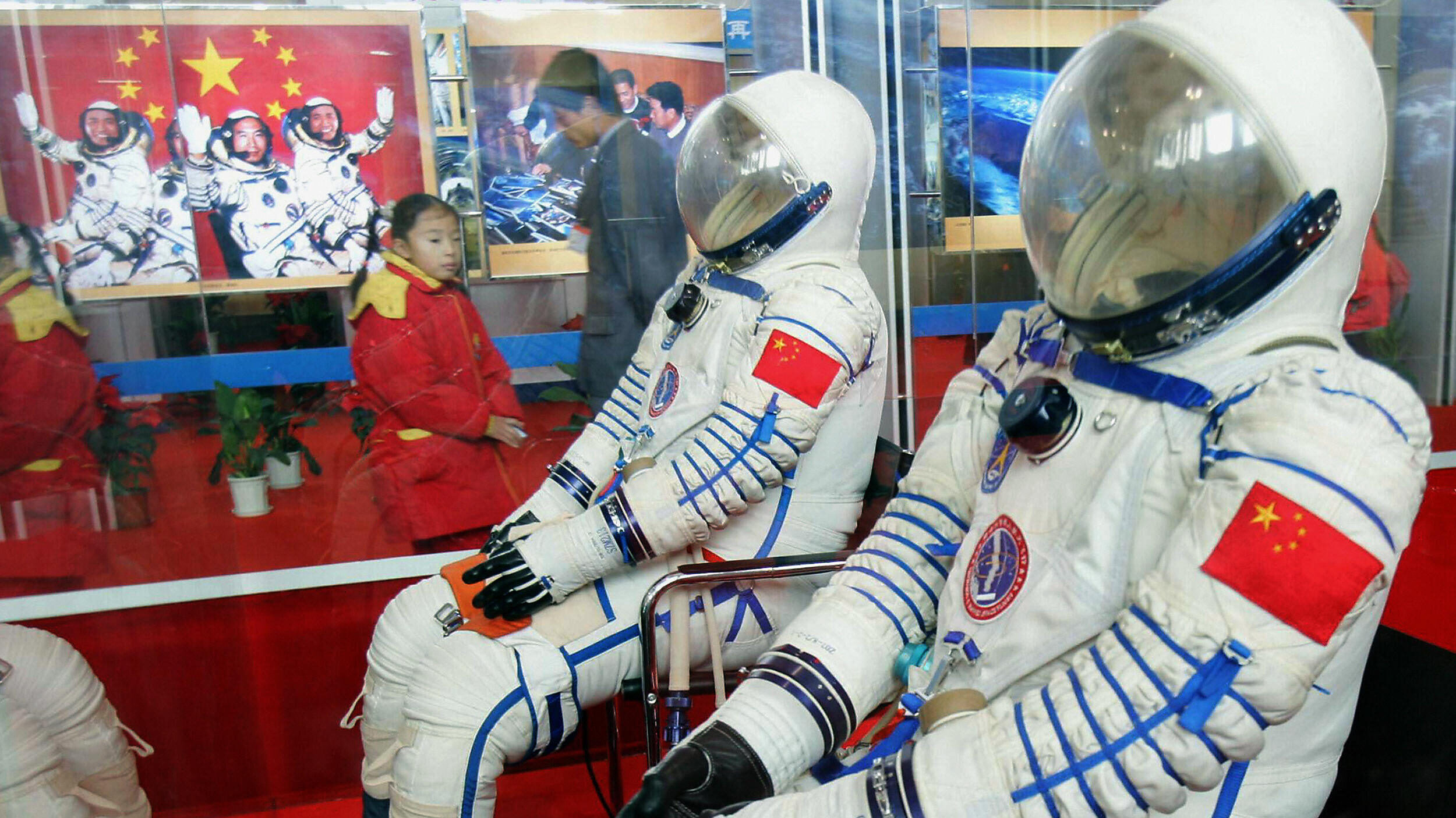 Visitors admire the spacesuits that Fei