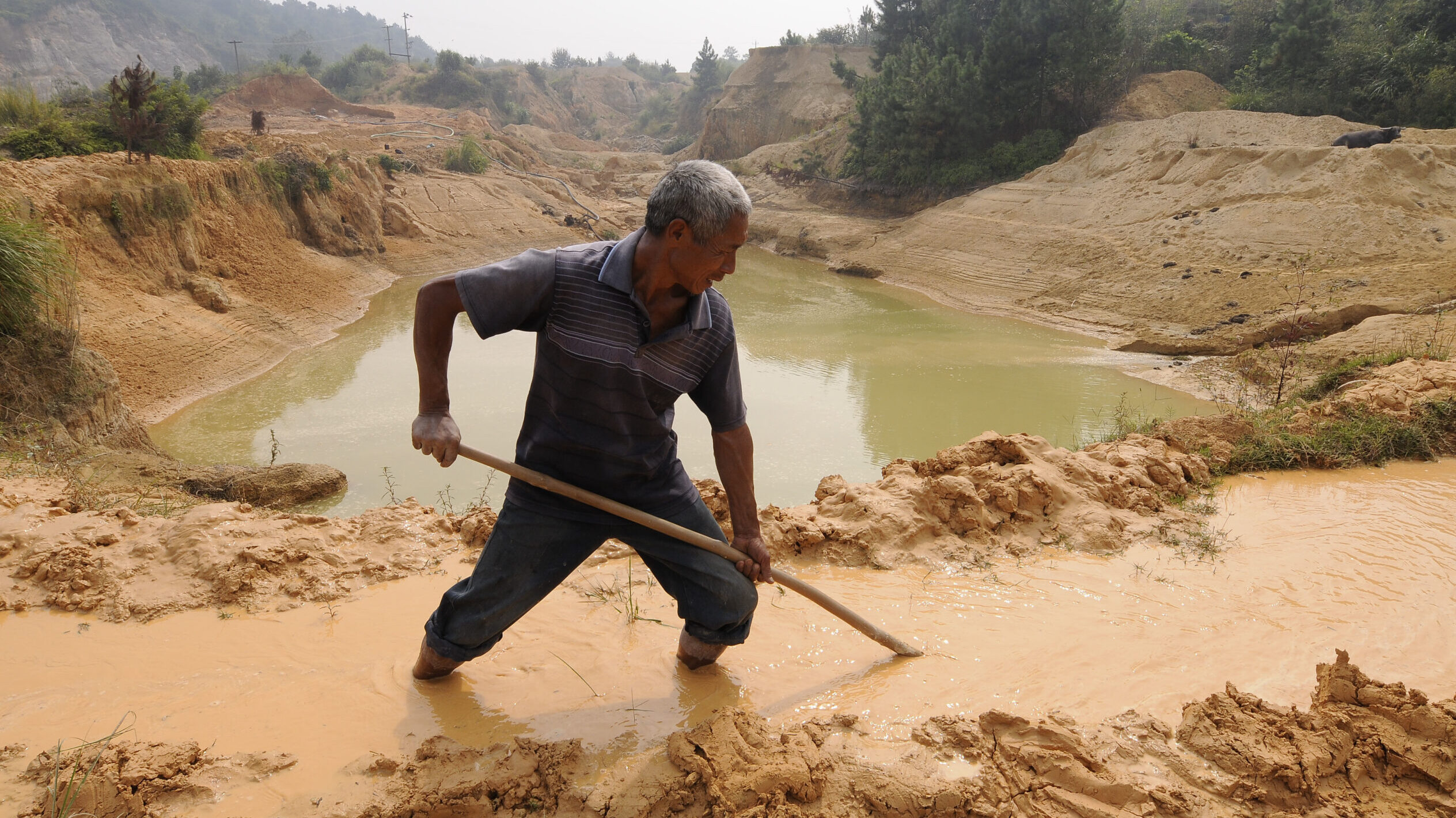 A labourer works at the site of a rare earth metals mine at Nancheng county, Jiangxi province china
