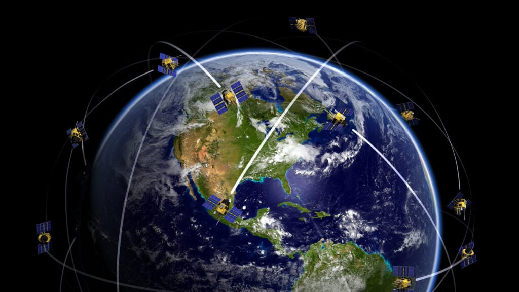 Satellites over world globe monitoring GPS localization
