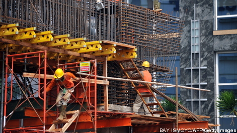 Labourers work on a construction site in